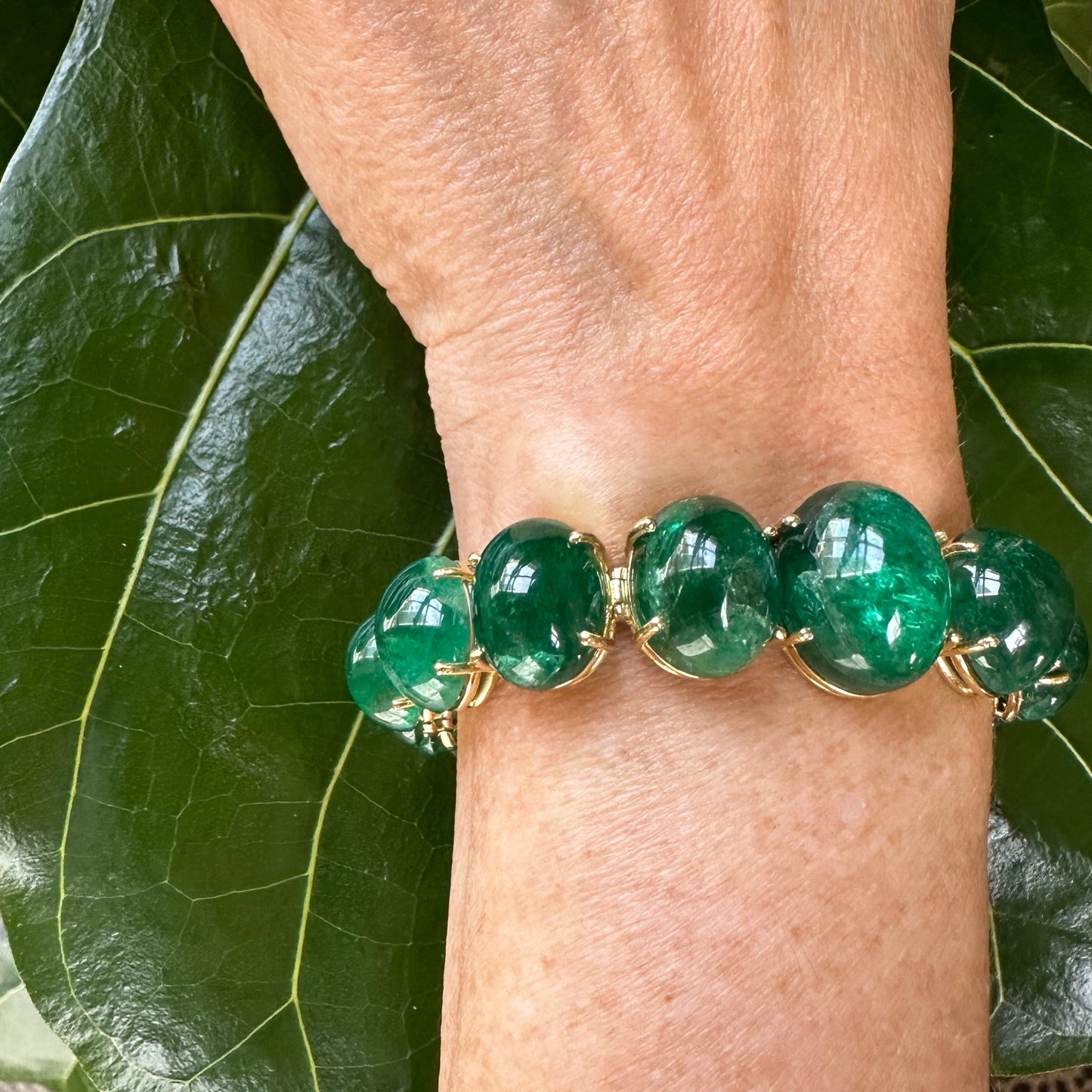 Graduated Cabochon Emerald Bracelet | 16 Vivid Green Oval Emeralds | 111.64ct | 18k Yellow Gold | 7"