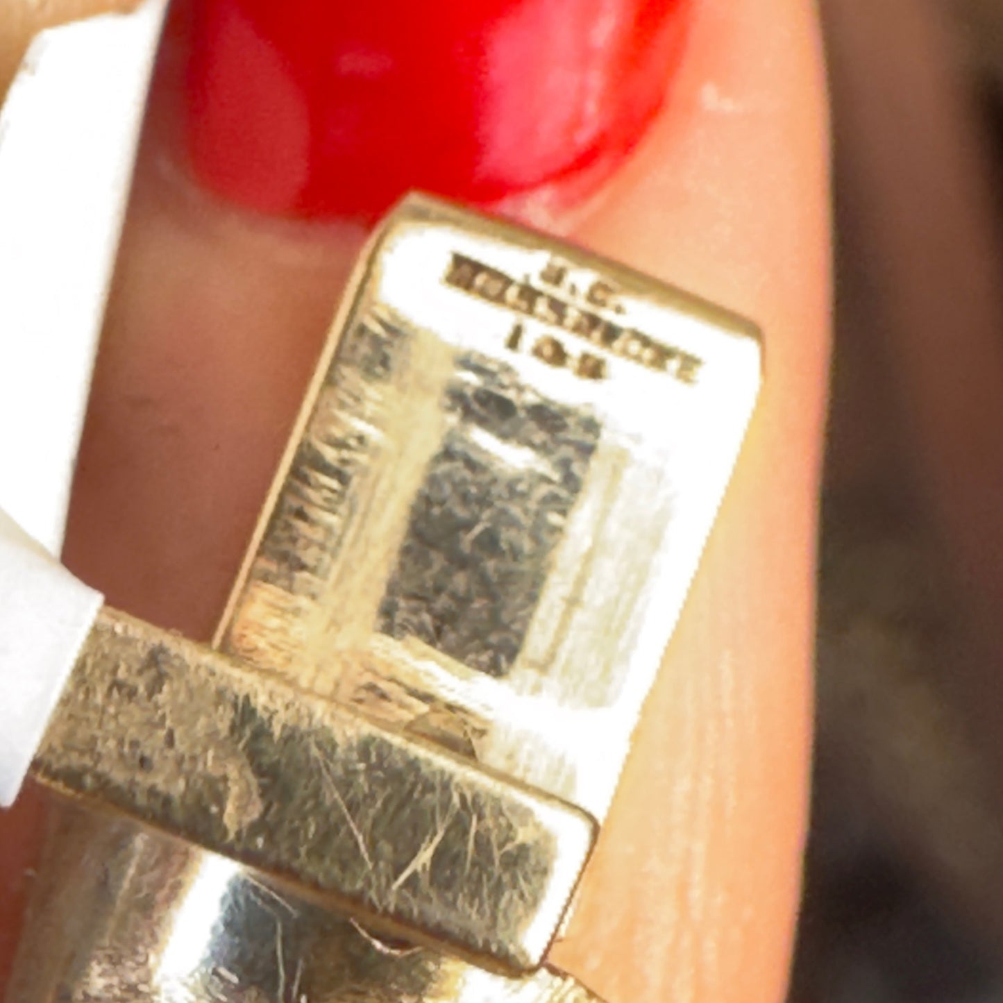 Close-up of a gold tongue with visible hallmarks M.C. MOSSALONE 14K