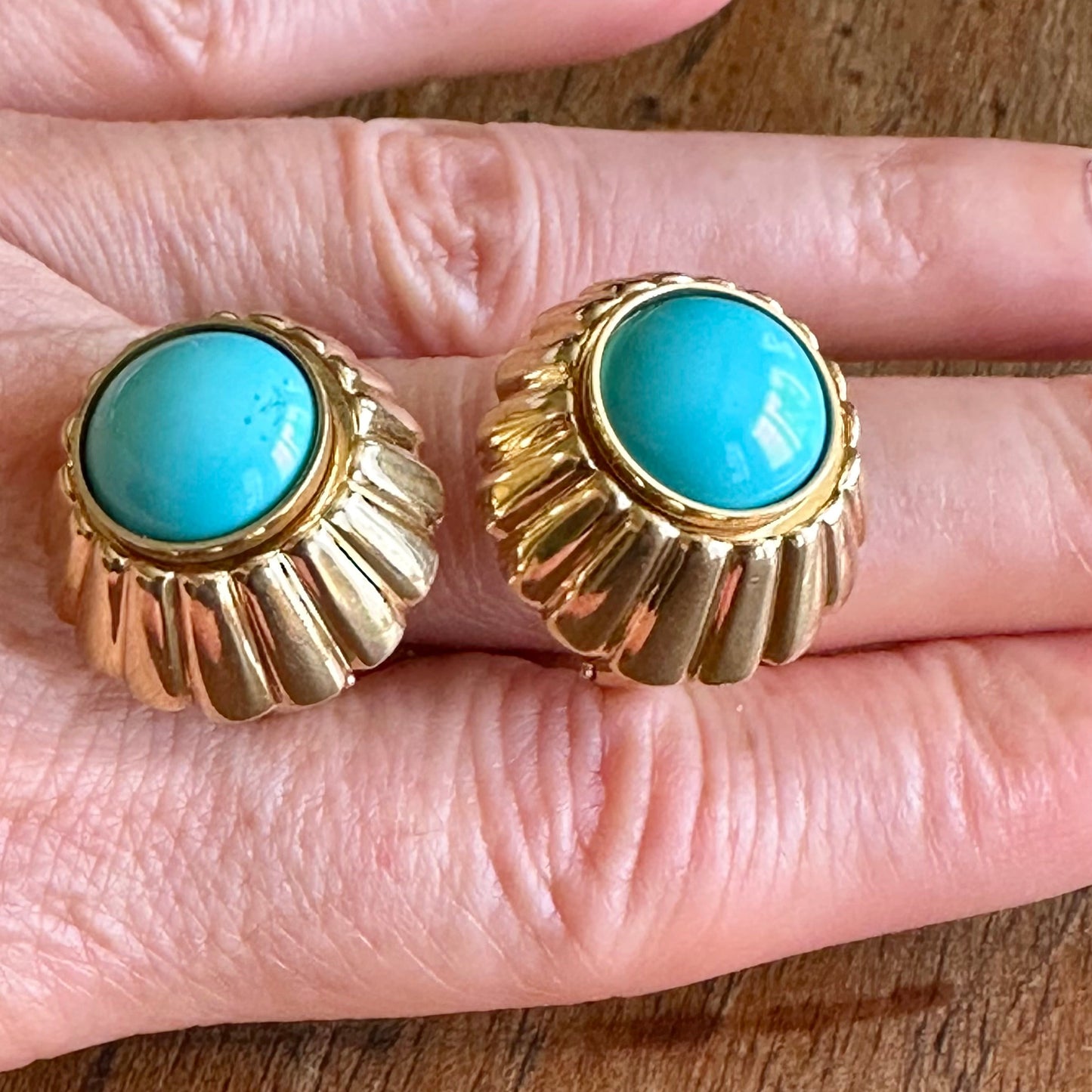 A pair of vintage gold-tone clip-on earrings with oval turquoise cabochon stones